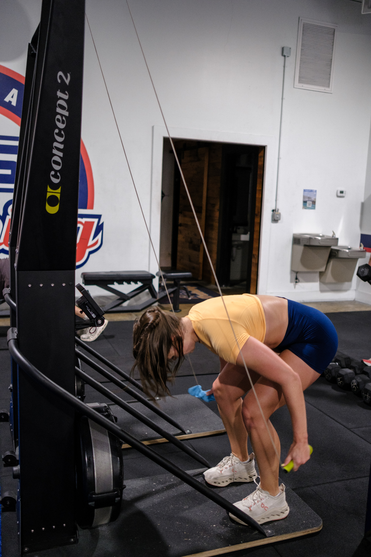 Athlete in mid-stroke on a Concept2 SkiErg, capturing strength and form