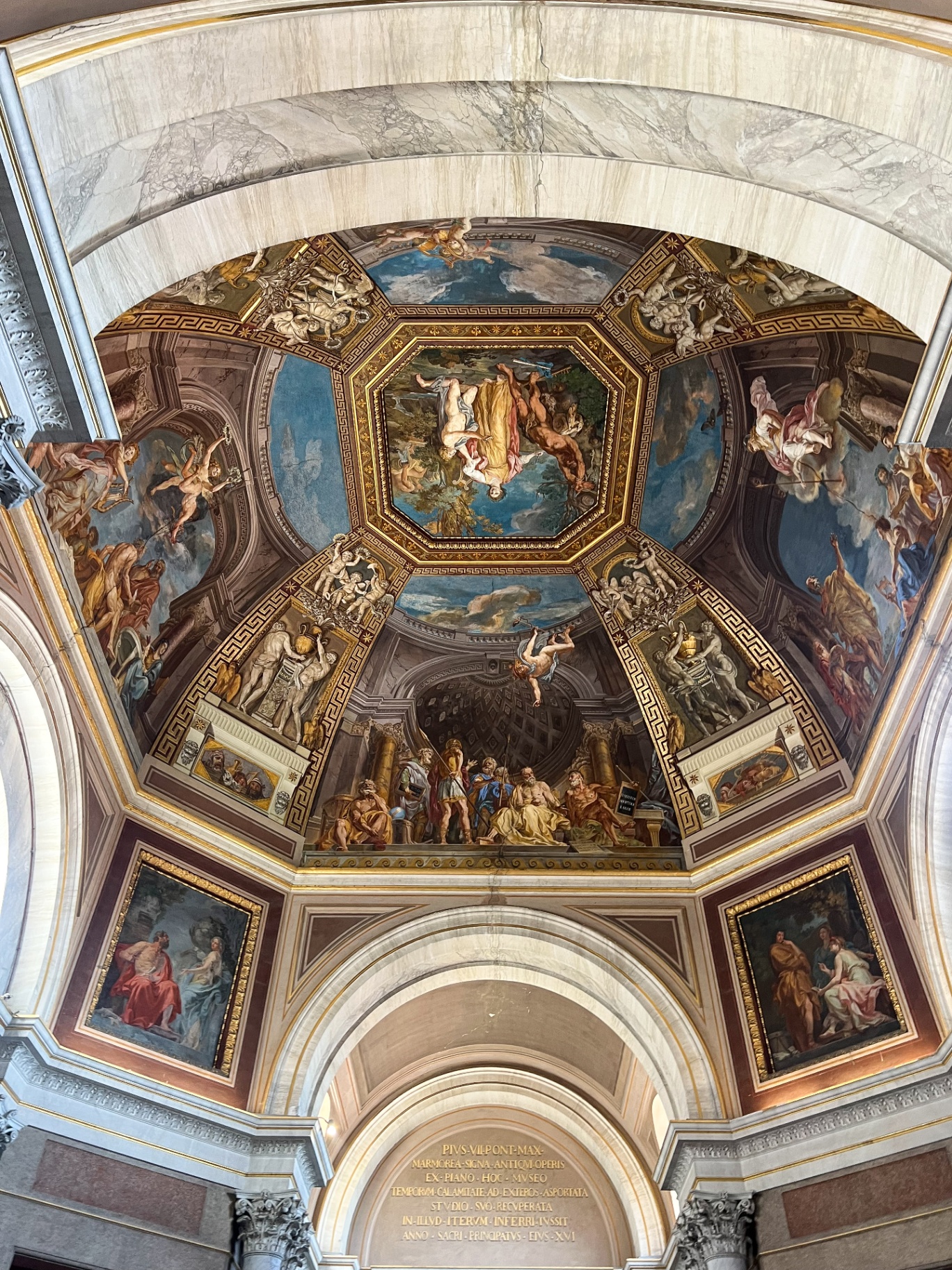 Painted vaulted ceiling with ornate frescoes and classical architectural details in Rome