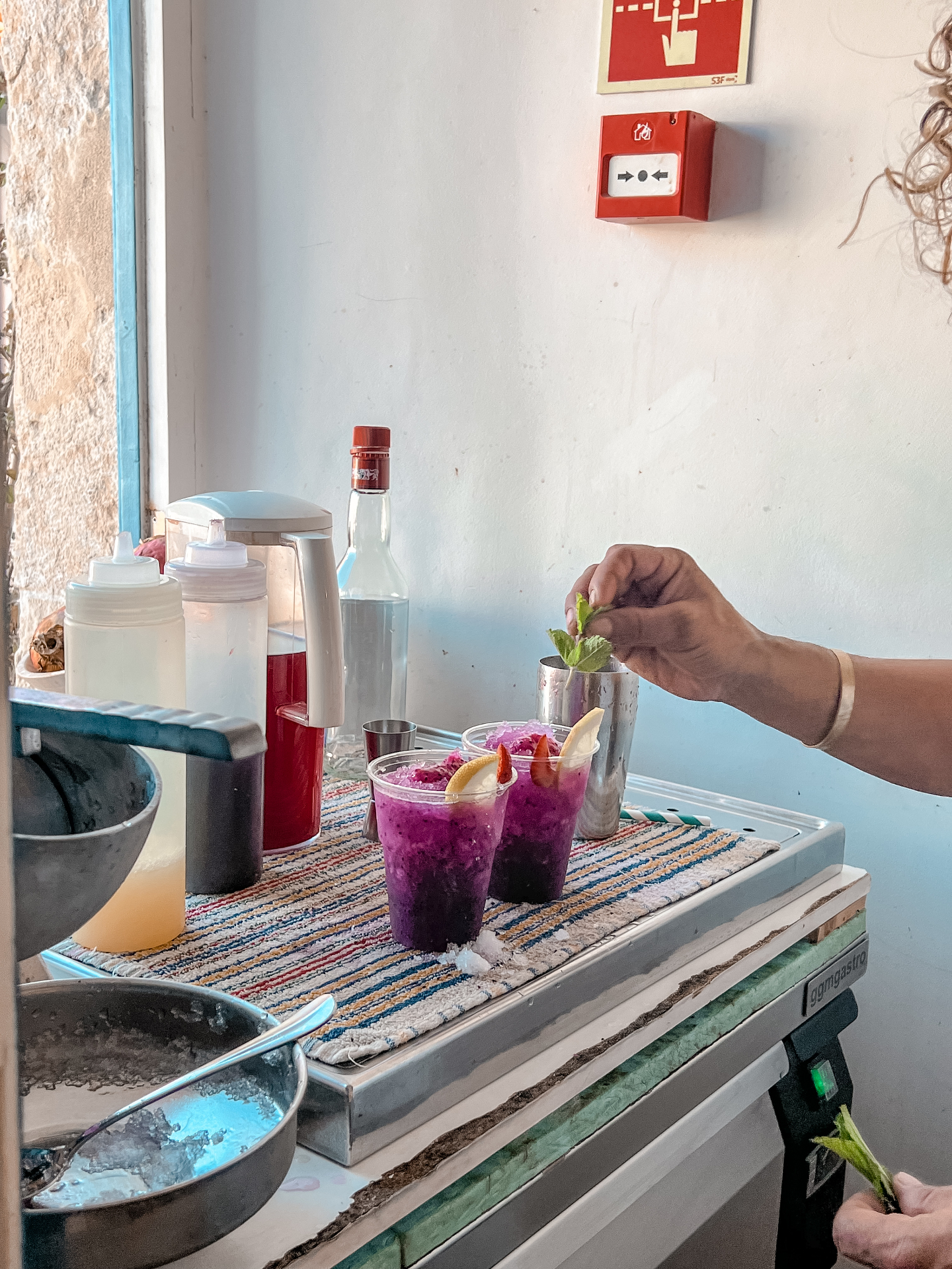 Fresh dragonfruit drinks being garnished at a coastal café