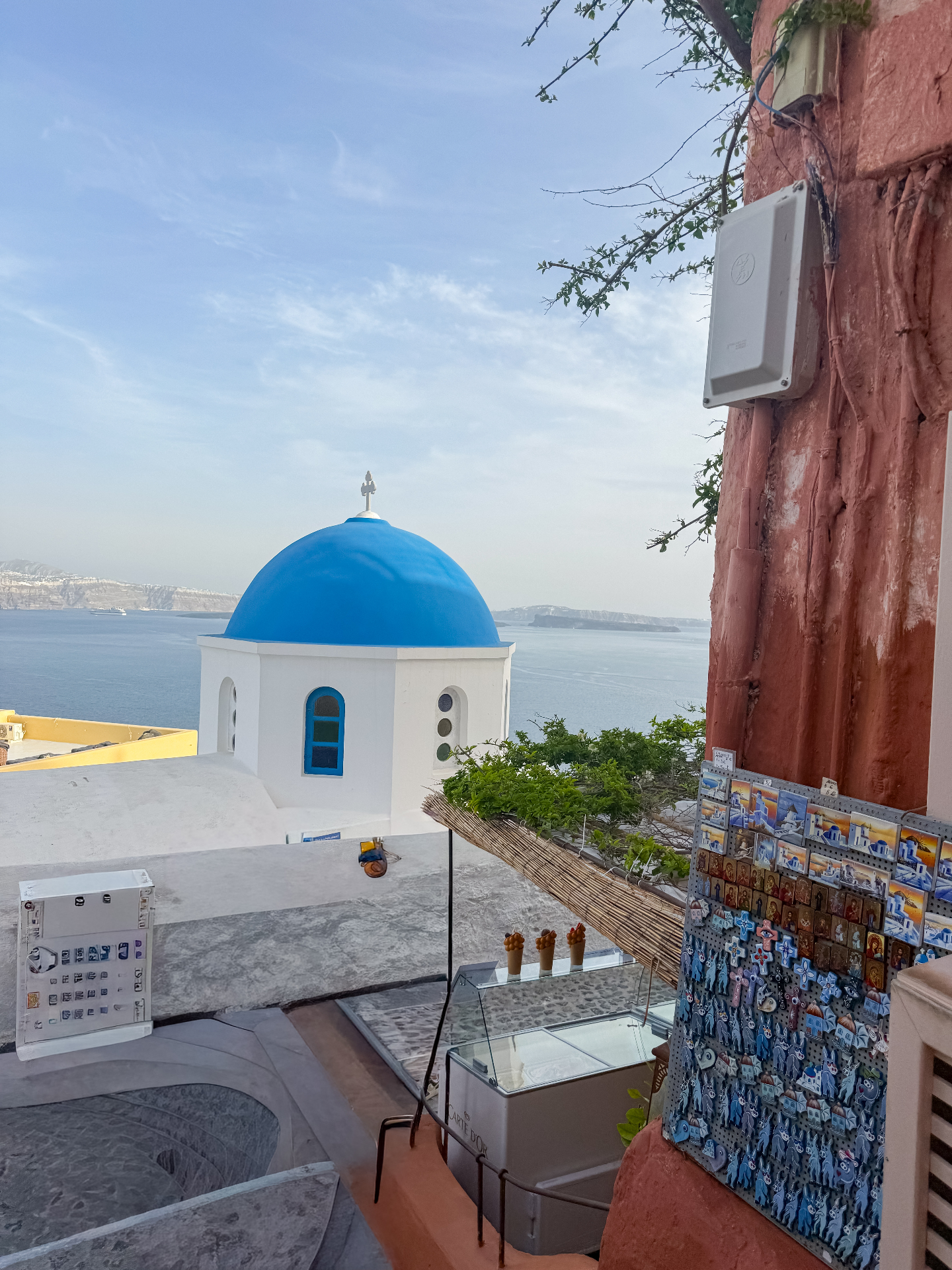 Blue-domed chapel overlooking the sea in Santorini, Greece